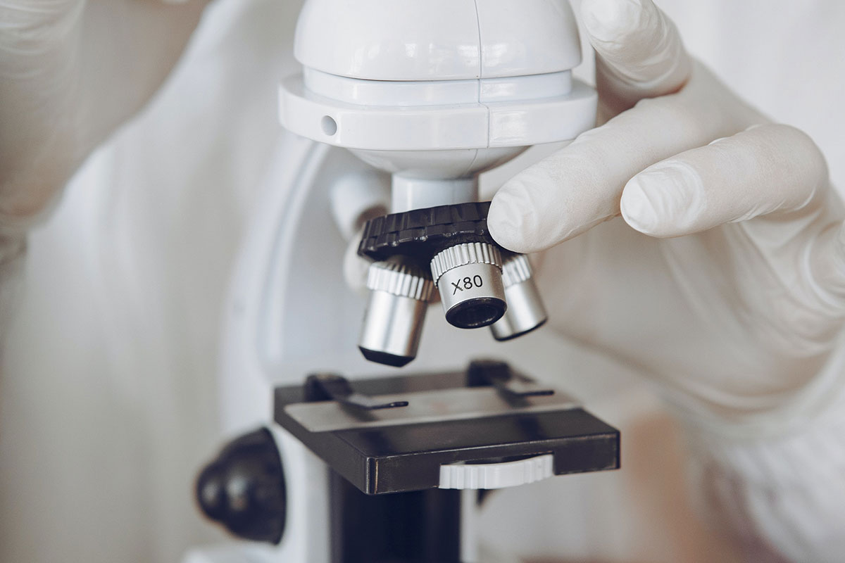 Person holding microscope