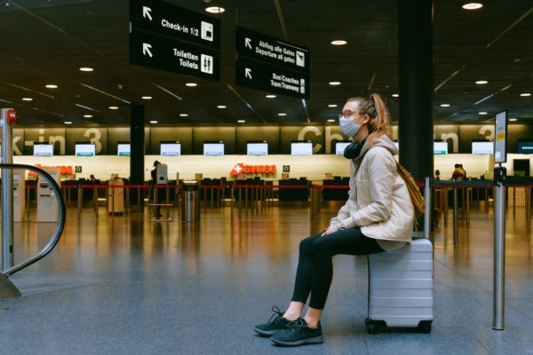 Woman sitting on luggage