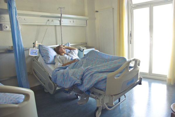 A woman lying in a hospital bed