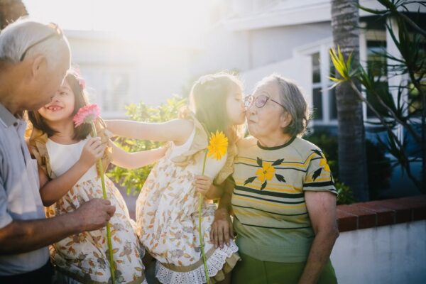 Children hugging their grandparents