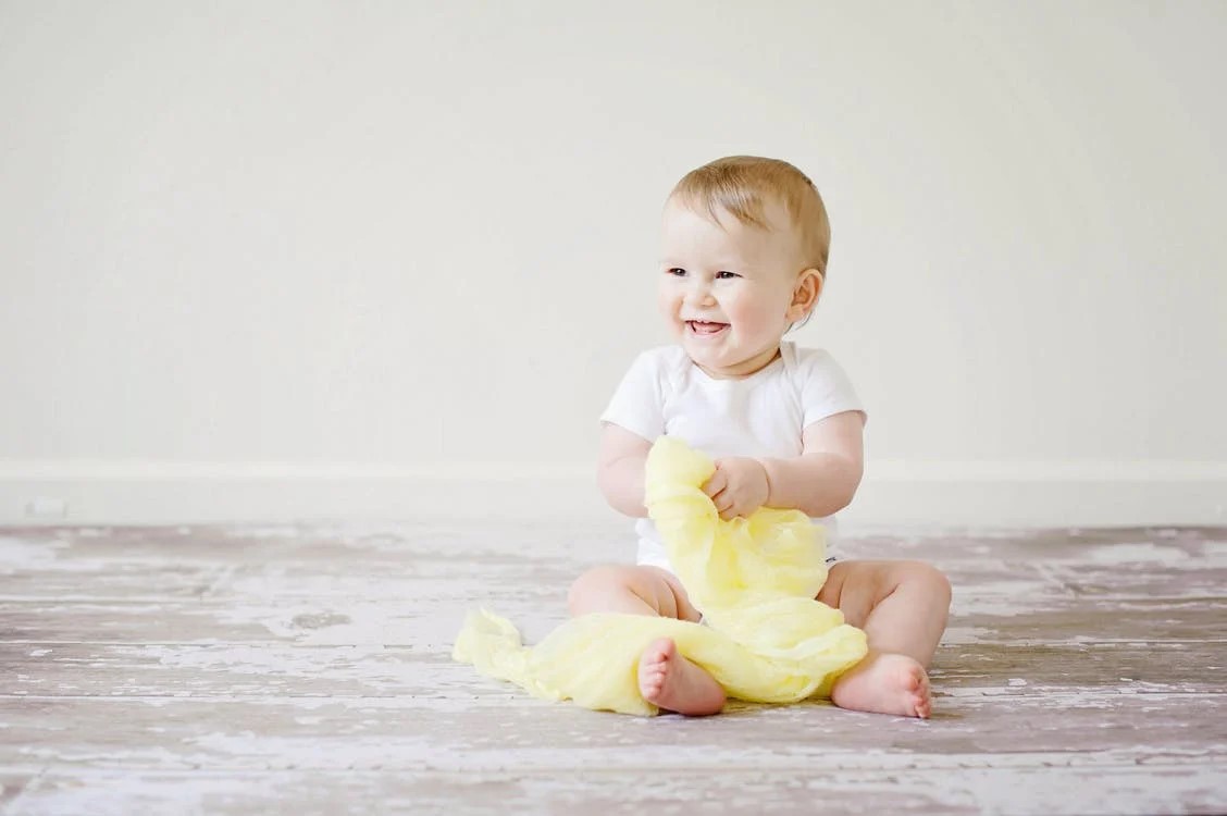 A baby playing on the floor