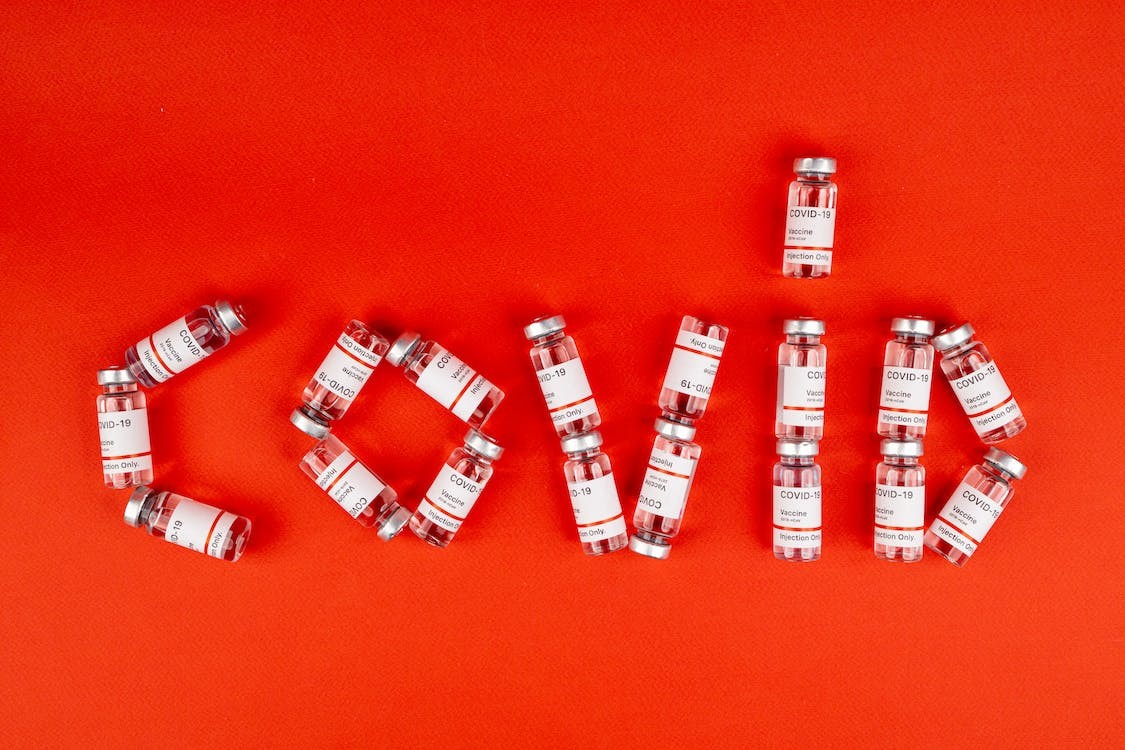 Covid-19 vaccine bottles marking up the word Covid