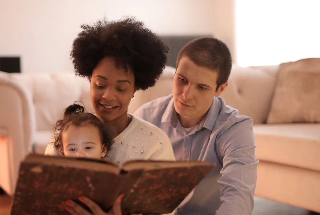 Parents reading to a small child