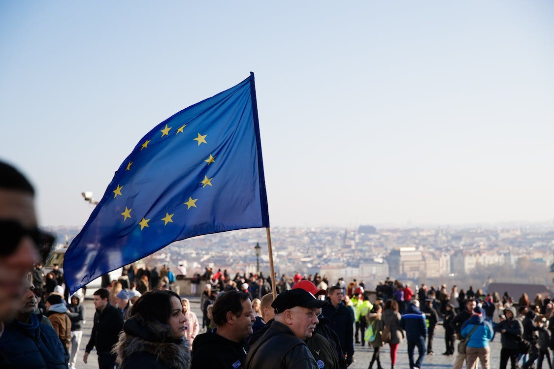 A crowd with an EU flag