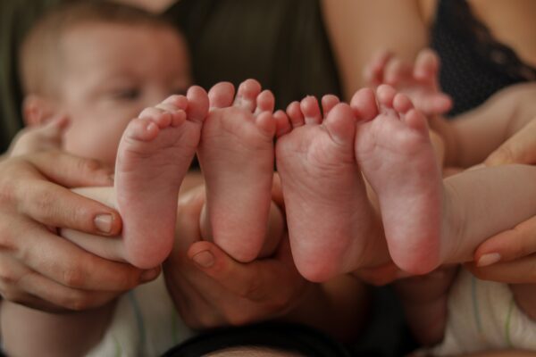 Feet sool of two babies up close