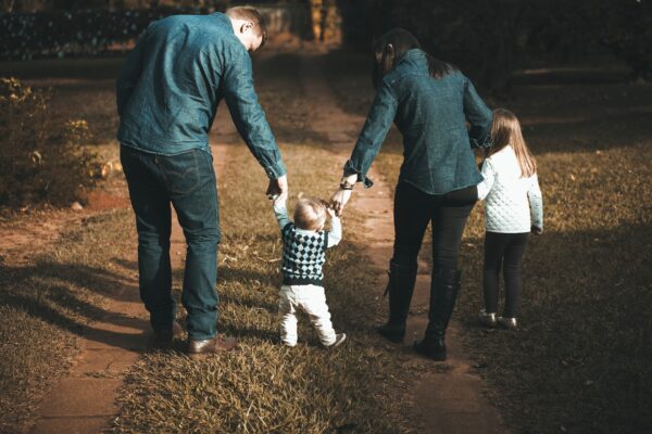 Family with two small children walking on a path