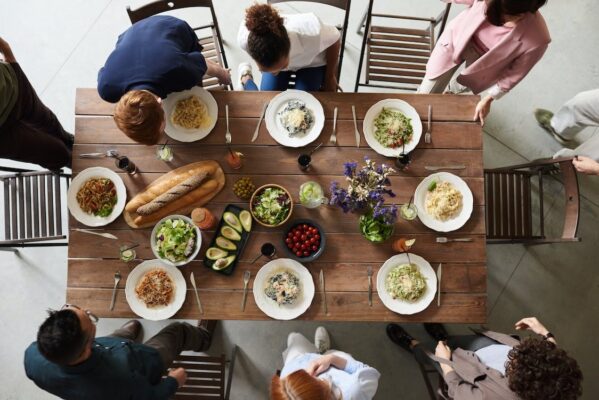Bird view of a dinner table with people eating healthy food