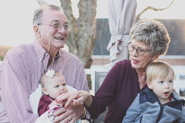 Grandparents with grandchildren on their laps