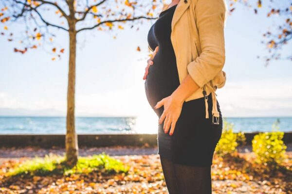 A pregnant woman holding her belly
