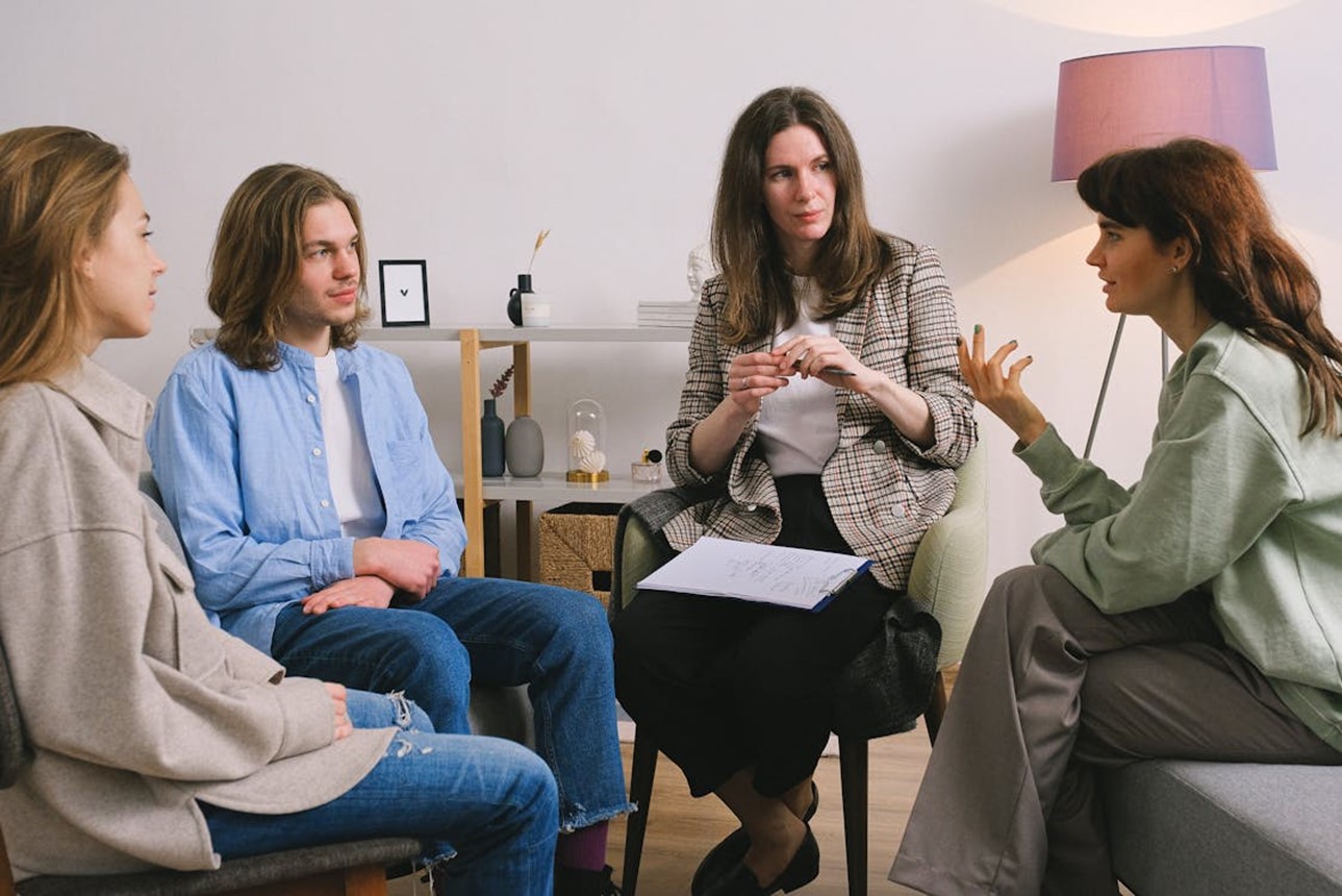 Group of people talking under guidance of a therapist