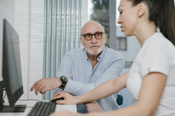 Elderly Man wearing Eyeglasses looking at a Woman