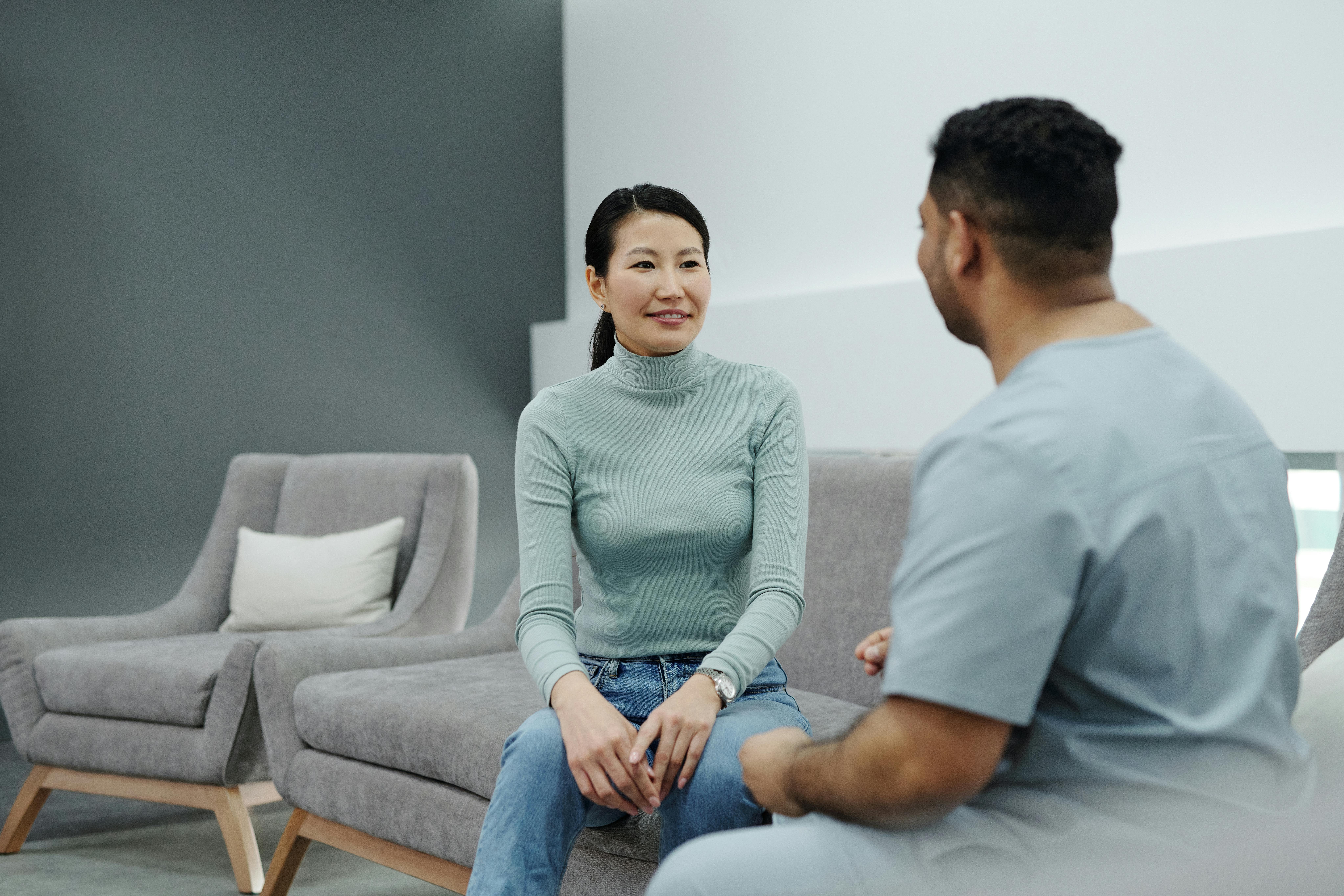 Healthcare professional talking to patient in a cozy sitting area