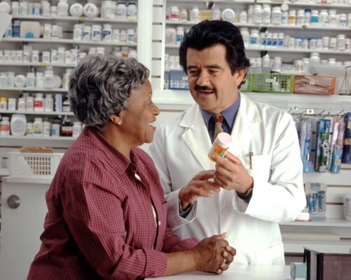 Pharmacist giving advise to elderly person