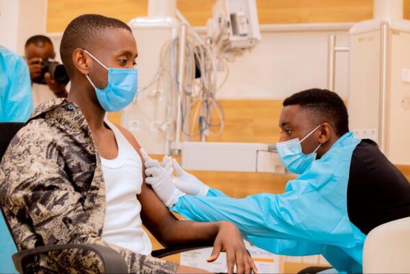 Rwandan being vaccinated