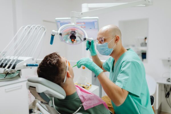 A dentist treating a patient lying in a dentist's chair